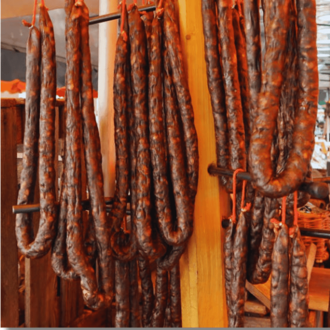 Figatellu Corse IGP sausages hanging, showcasing traditional Corsican charcuterie.